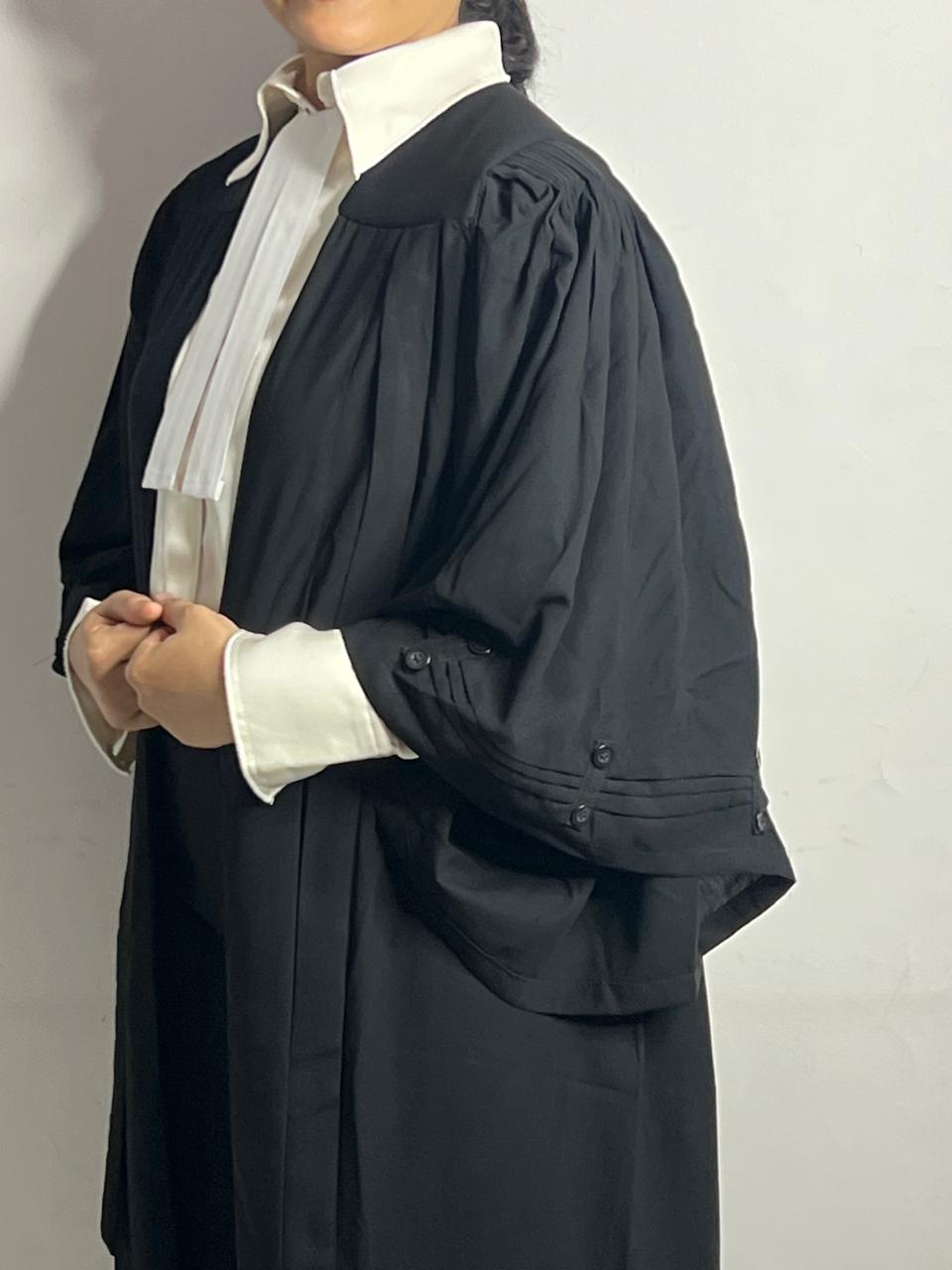 Women wearing lawyer gown and flexing it's fit