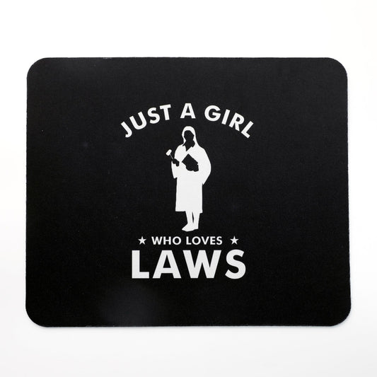 A black mousepad with a white printed text 'JUST A GIRL WHO LOVES LAWS' and an illustration of a woman in a black dress holding a baby.