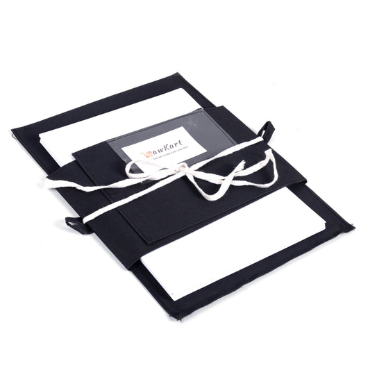 Black fabric-covered photo album with a white ribbon on a white background