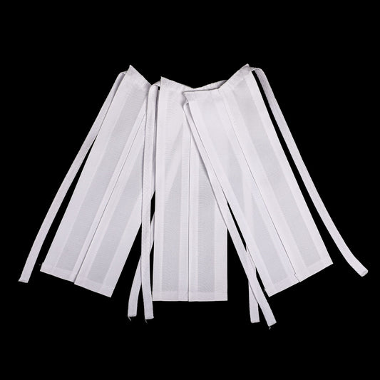 Three white cotton lawyer's bands laid out on a plain background, showcasing their design and fabric.