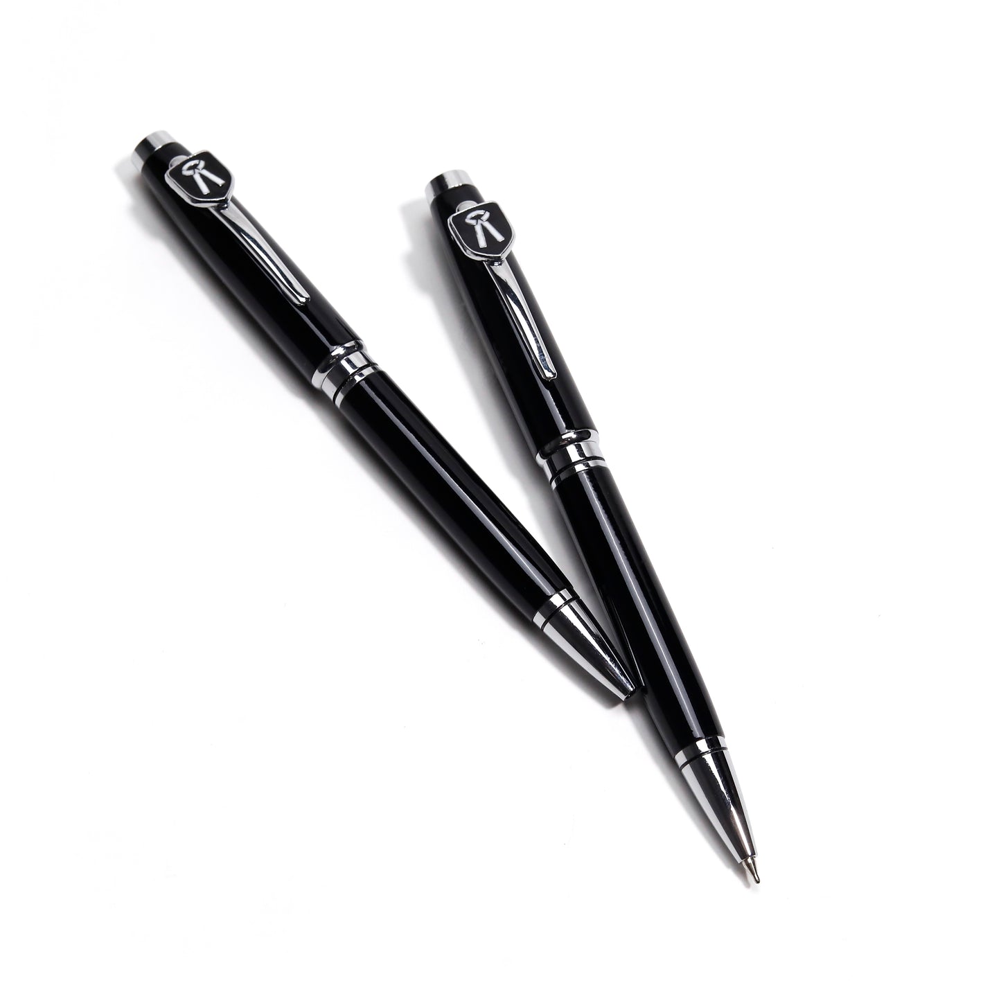 Two black pens with silver accents on a white background