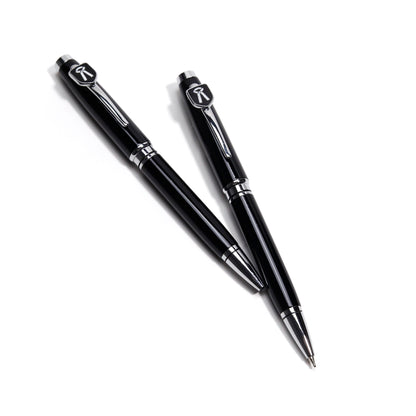 Two black pens with silver accents on a white background