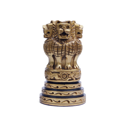 A wooden Ashoka Stambh featuring a sculpture of four lions standing back to back on a base, with intricate carvings.