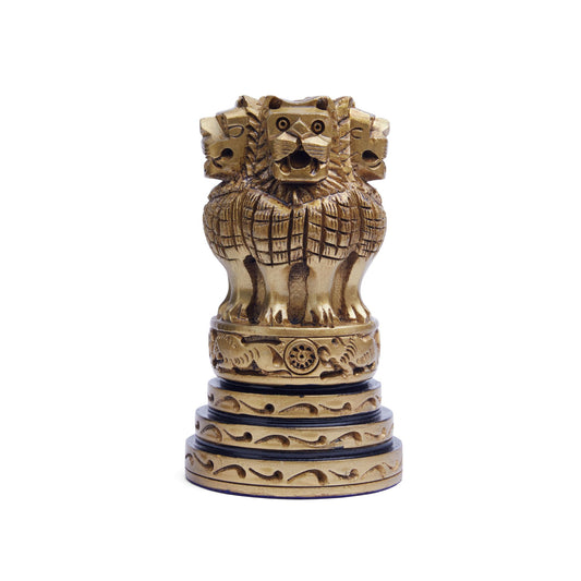 A wooden Ashoka Stambh featuring a sculpture of four lions standing back to back on a base, with intricate carvings.